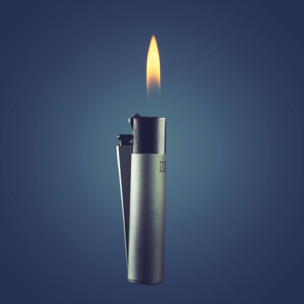black disposable lighter on blue surface