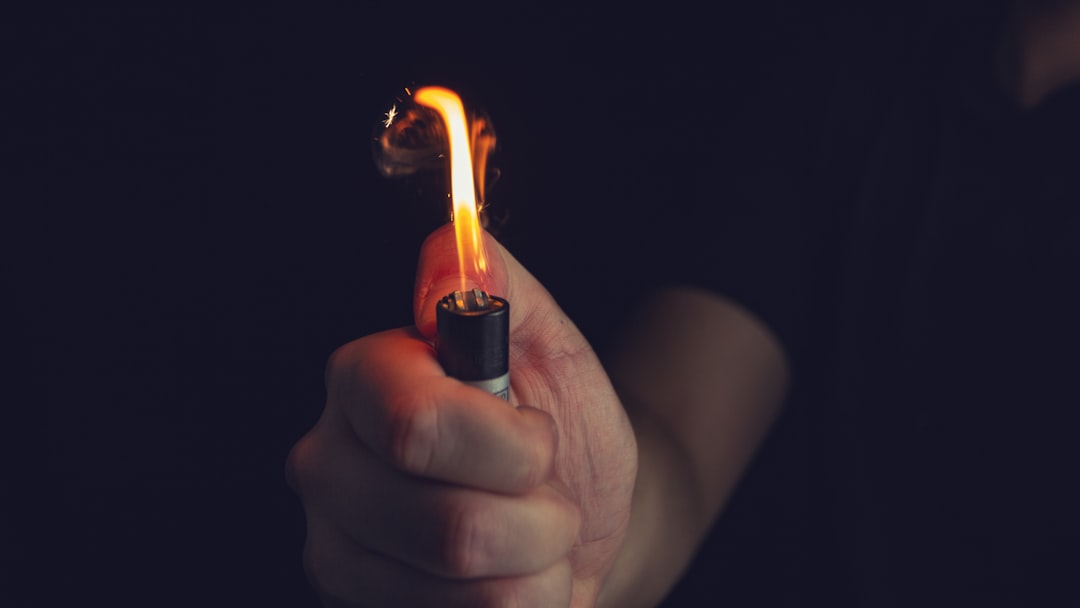 person holding black disposable lighter