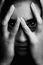grayscale photo of woman covering her face
