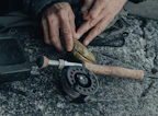 Close-up of handcrafted fishing hooks and lines arranged neatly on a wooden table.