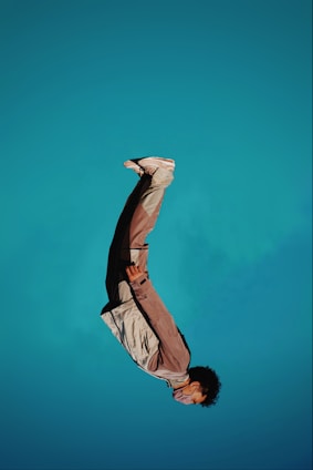 man in brown jacket and black pants