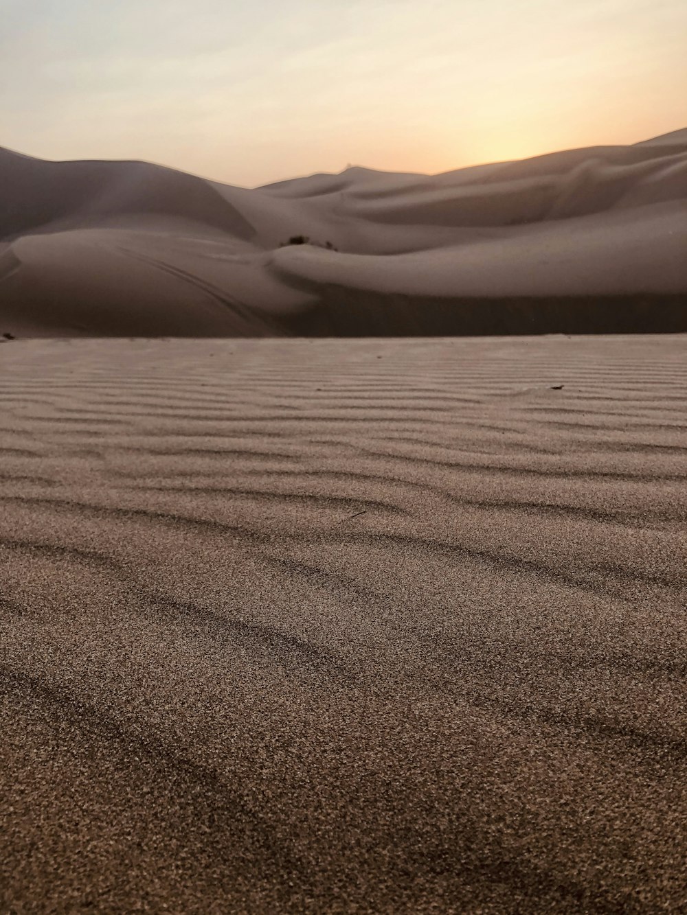 brown sand field during daytime