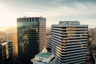An urban skyline with mid-rise office buildings bathed in morning light.