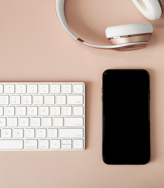 black iphone 7 beside white apple keyboard and white wireless computer mouse