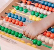 person holding red and blue abacus