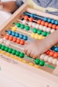 person holding red and blue abacus