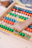 person holding red and blue abacus