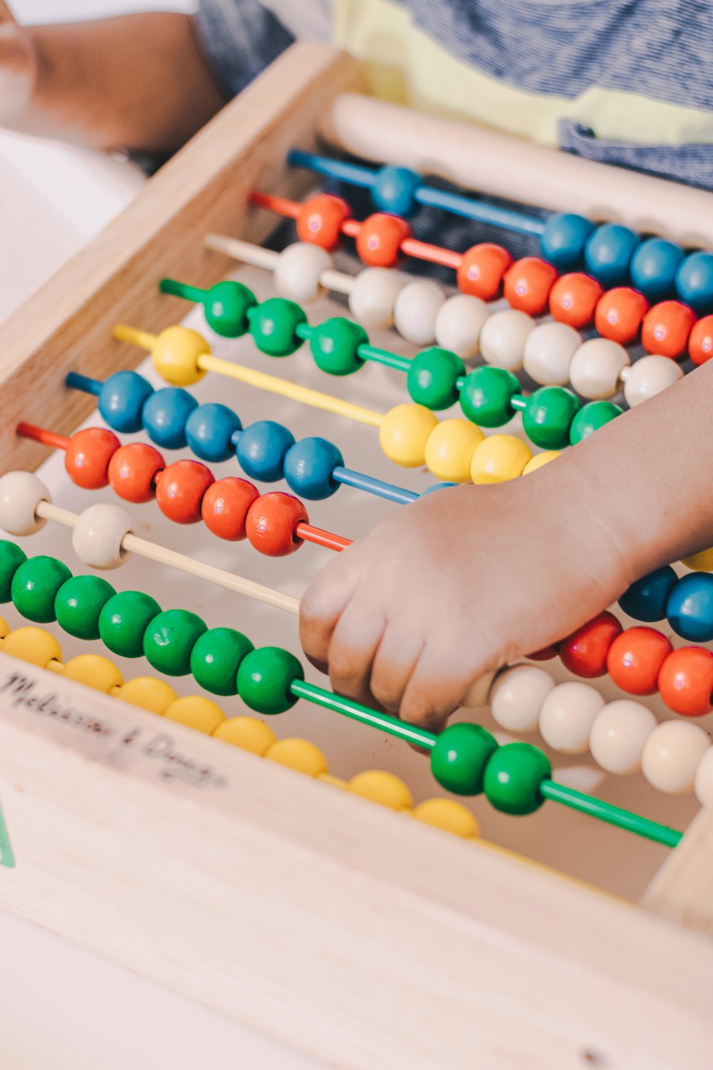 person holding red and blue abacus