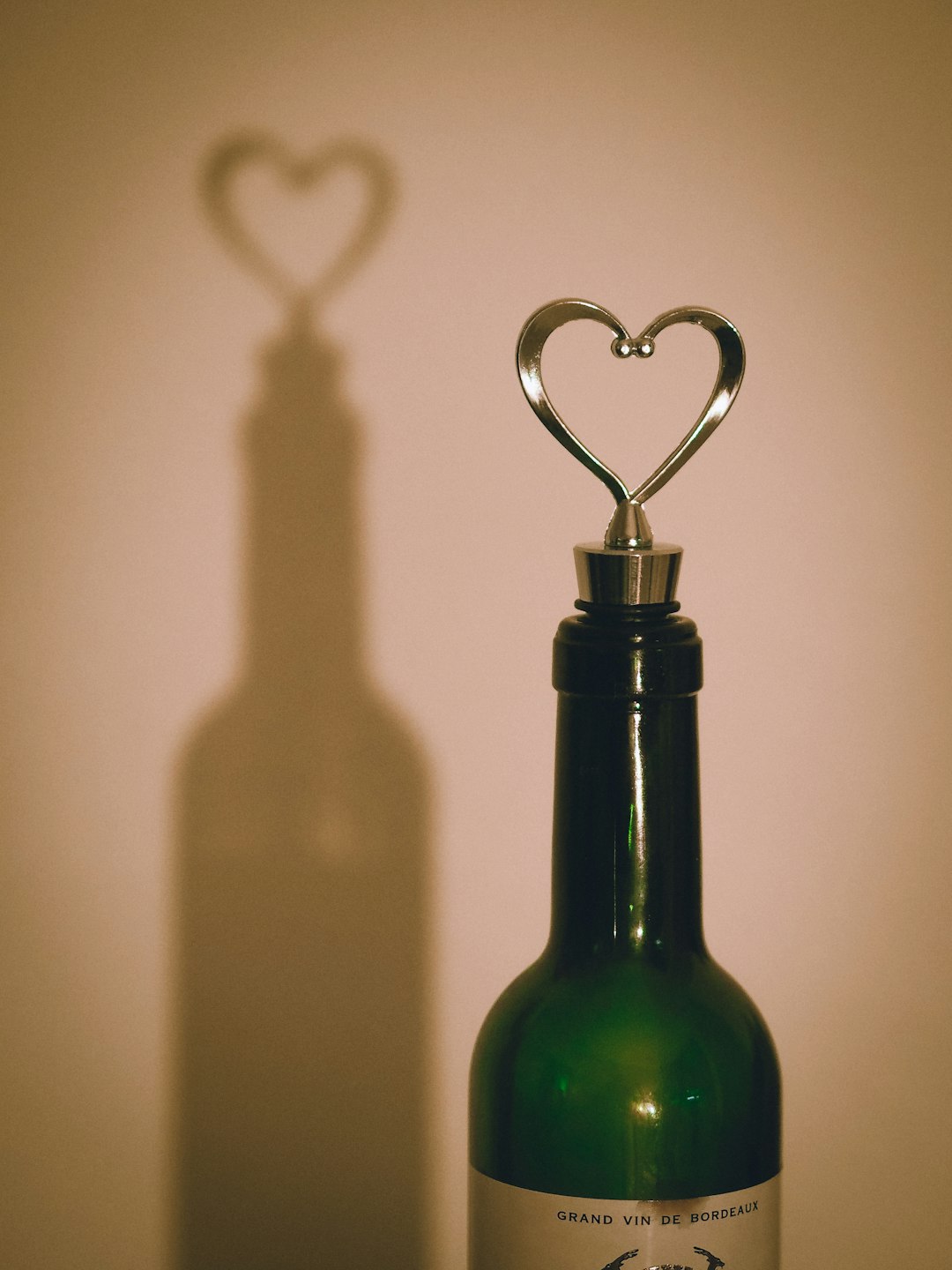 green glass bottle with silver hook