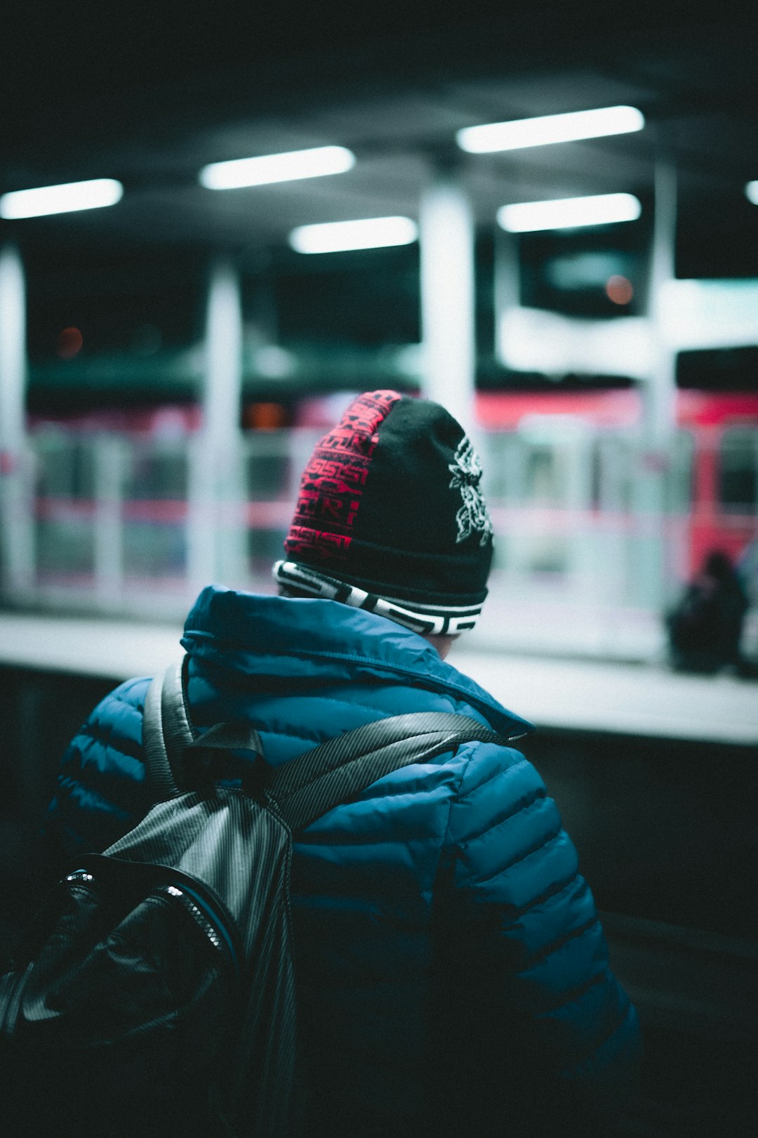 person in blue jacket and black and white knit cap