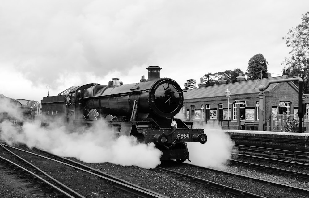 grayscale photo of train on rail tracks