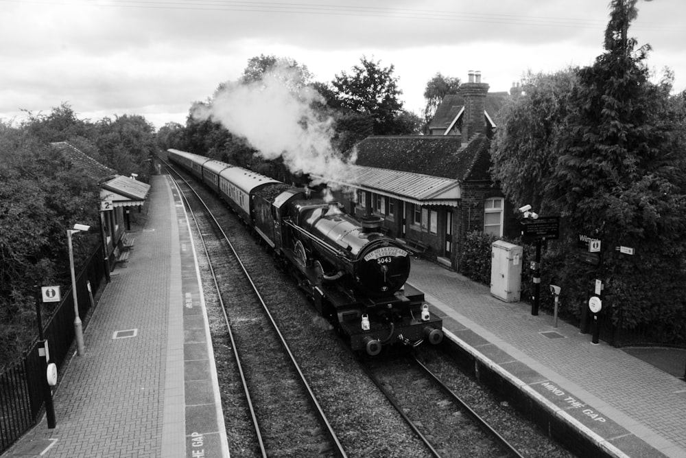 grayscale photo of train on rail tracks