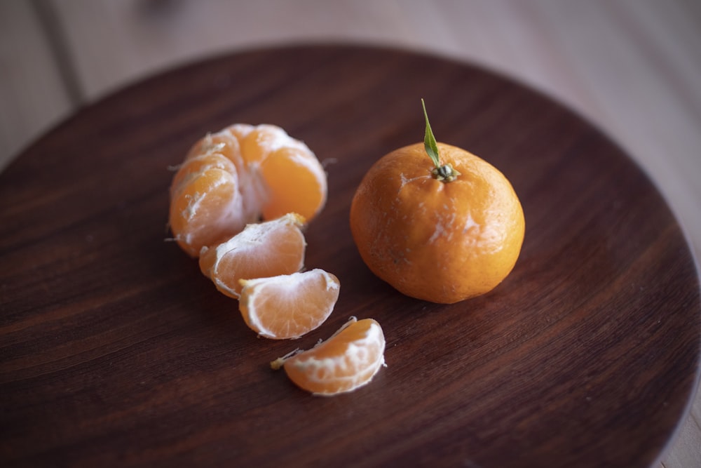 sliced oranges on brown wooden table