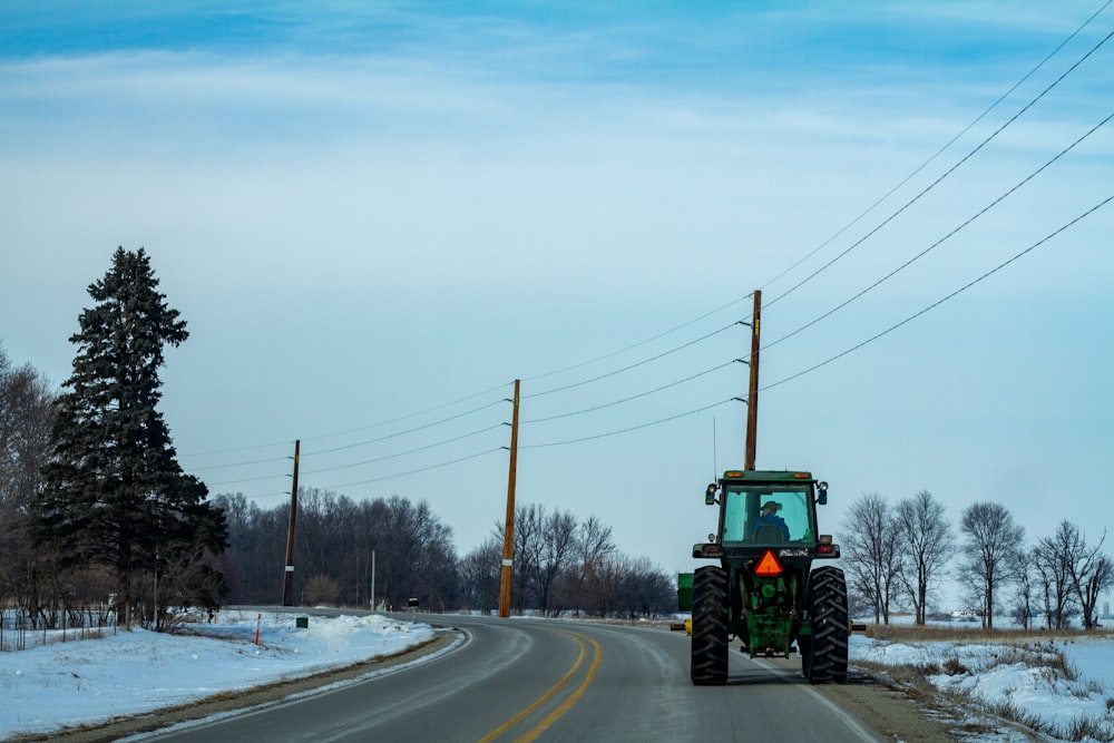 green tractor on road during daytime