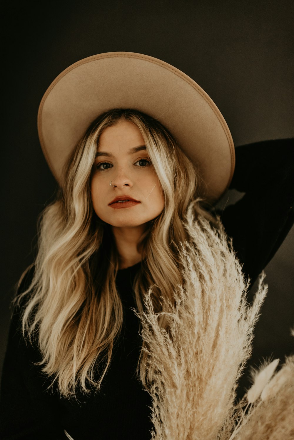 woman in black and white shirt wearing black hat