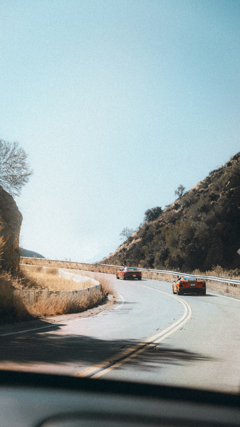 white car on road near mountain during daytime