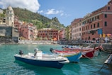 white and blue boat on water near buildings during daytime