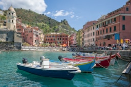 white and blue boat on water near buildings during daytime