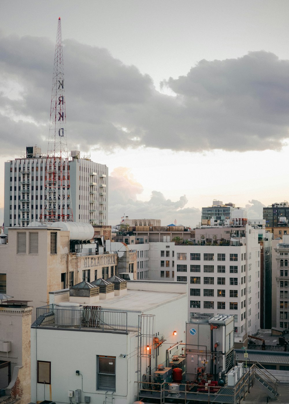 white and brown concrete buildings under white clouds during daytime