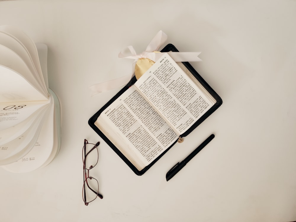 black framed eyeglasses on white table