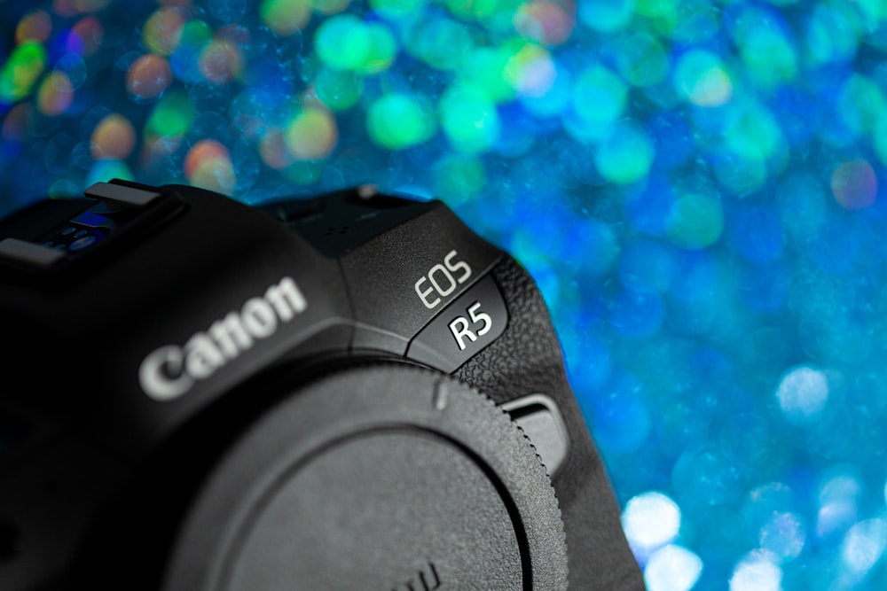 black nikon dslr camera on blue and white lights