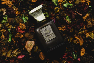 Elegant black and gold bottle of Lafiyah Boost with natural herbs around it