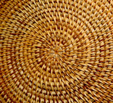 Close-up of intricately woven babaçu straw basket showcasing delicate textures and natural tones.