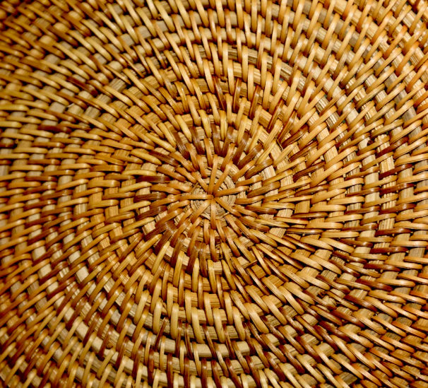 Close-up of sustainable woven basket with intricate patterns in warm tones