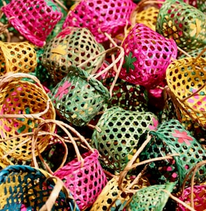 green and pink egg on brown woven basket