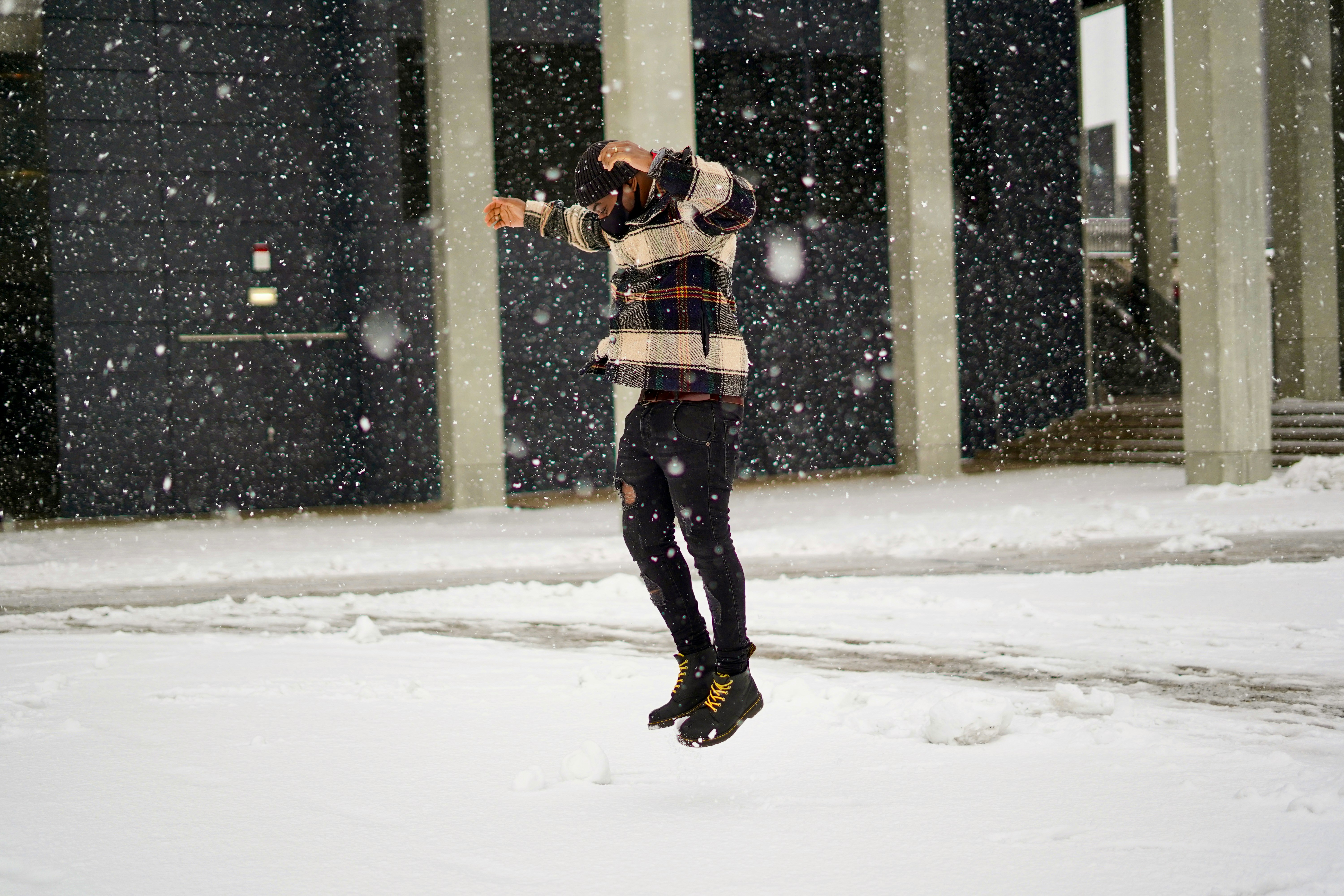 Men demonstrating layering system with shell jackets in a snowy environment