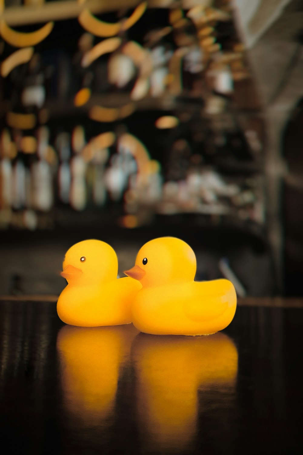 yellow rubber duck on brown wooden table