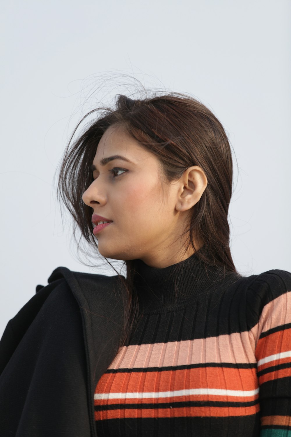 woman in black and orange striped shirt