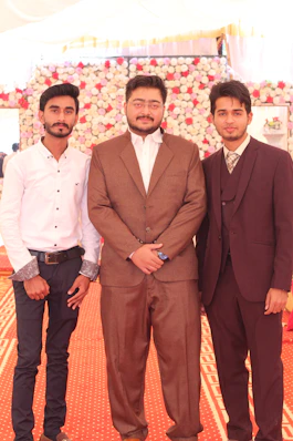 3 men in brown suit standing