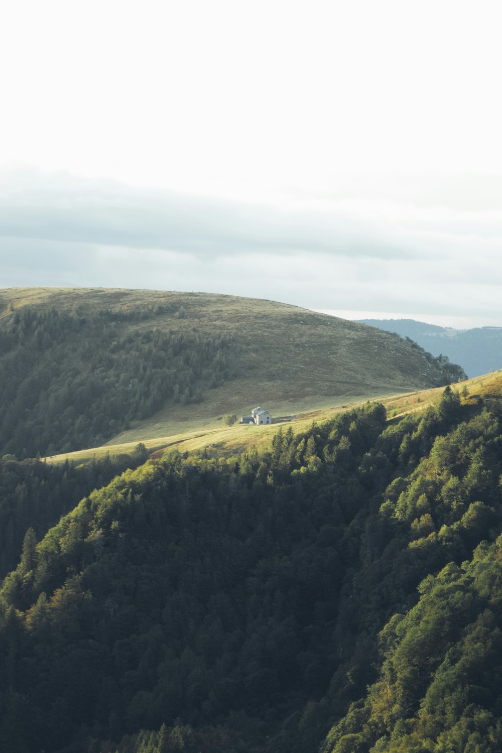 green and brown mountains under white sky during daytime