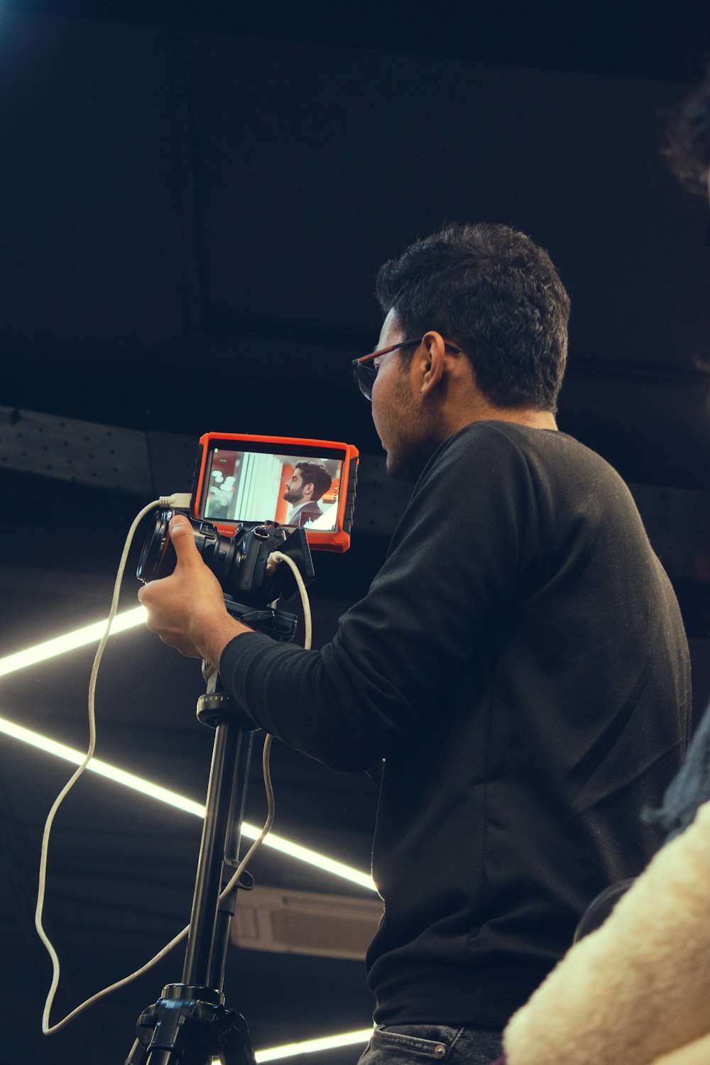 man in black long sleeve shirt holding white tablet computer