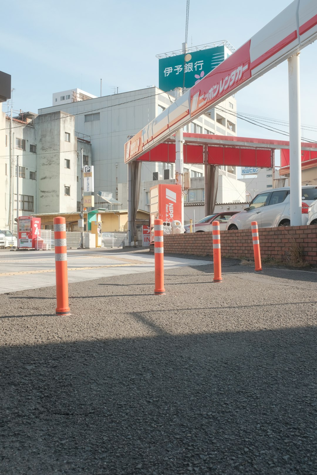 red and white metal post near white concrete building during daytime