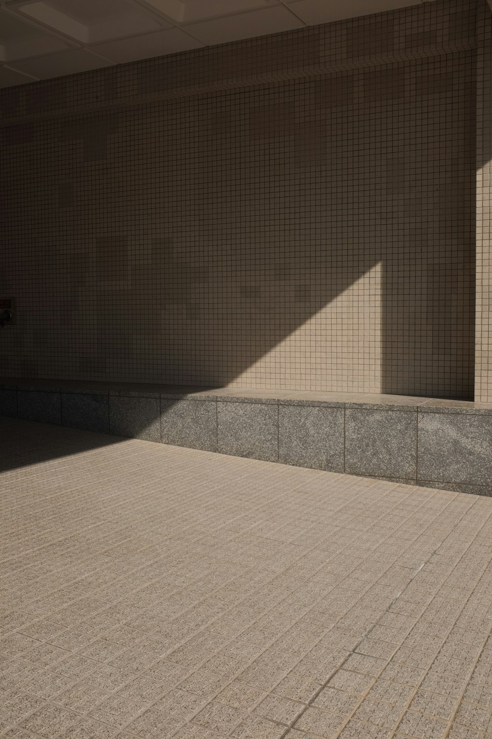 white ceramic tiles near brown wall