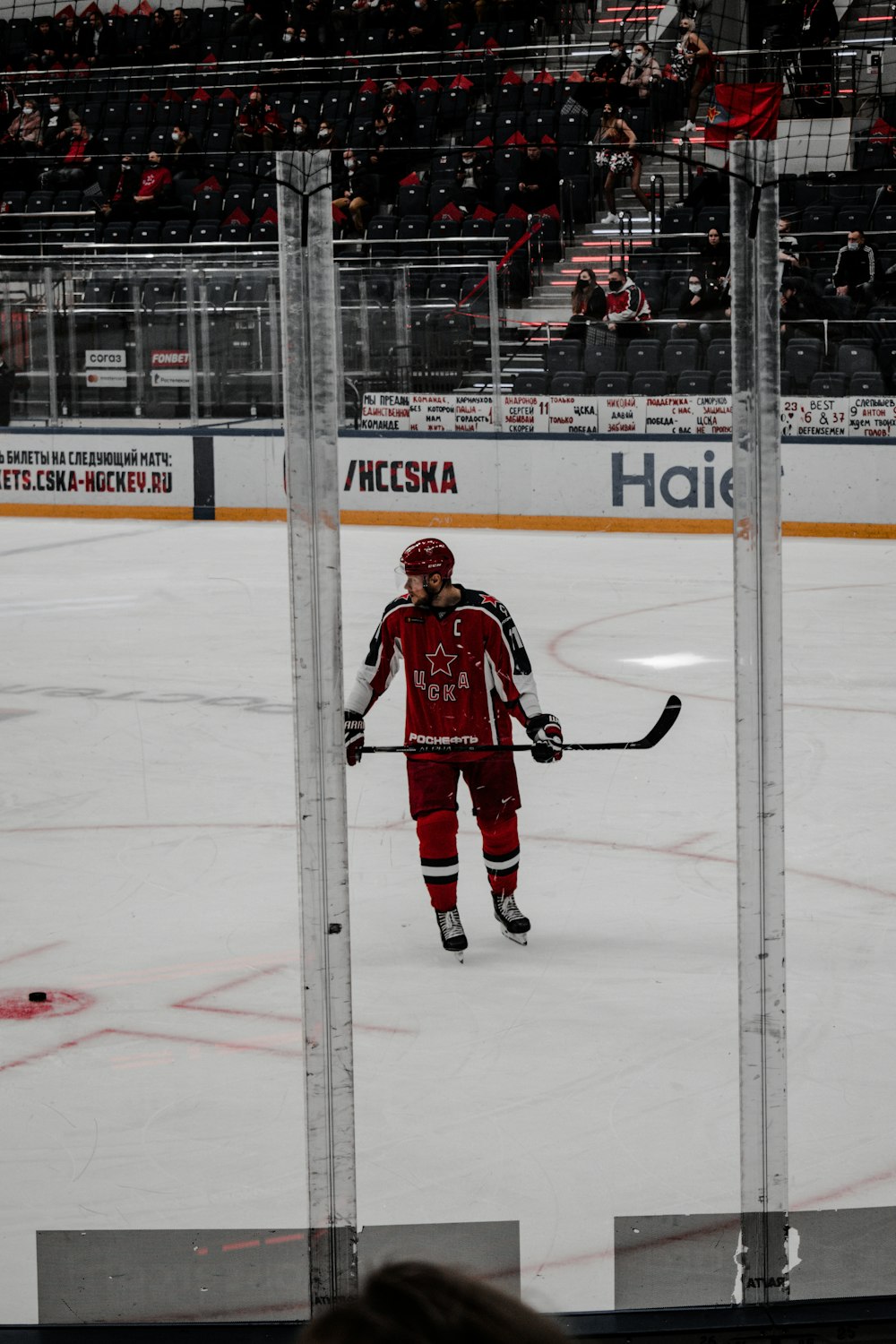 man in red ice hockey jersey playing ice hockey