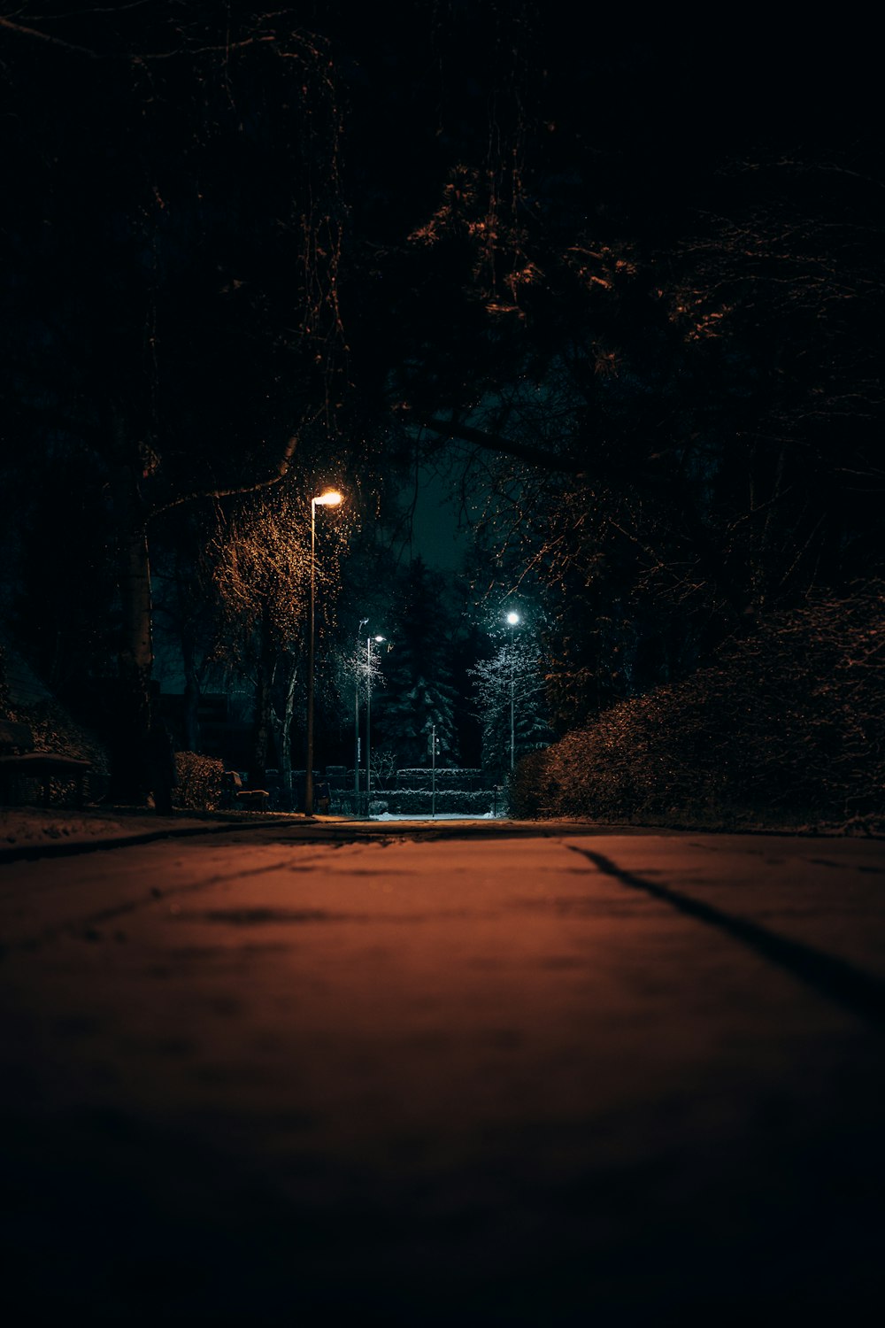 a dark street at night with street lights