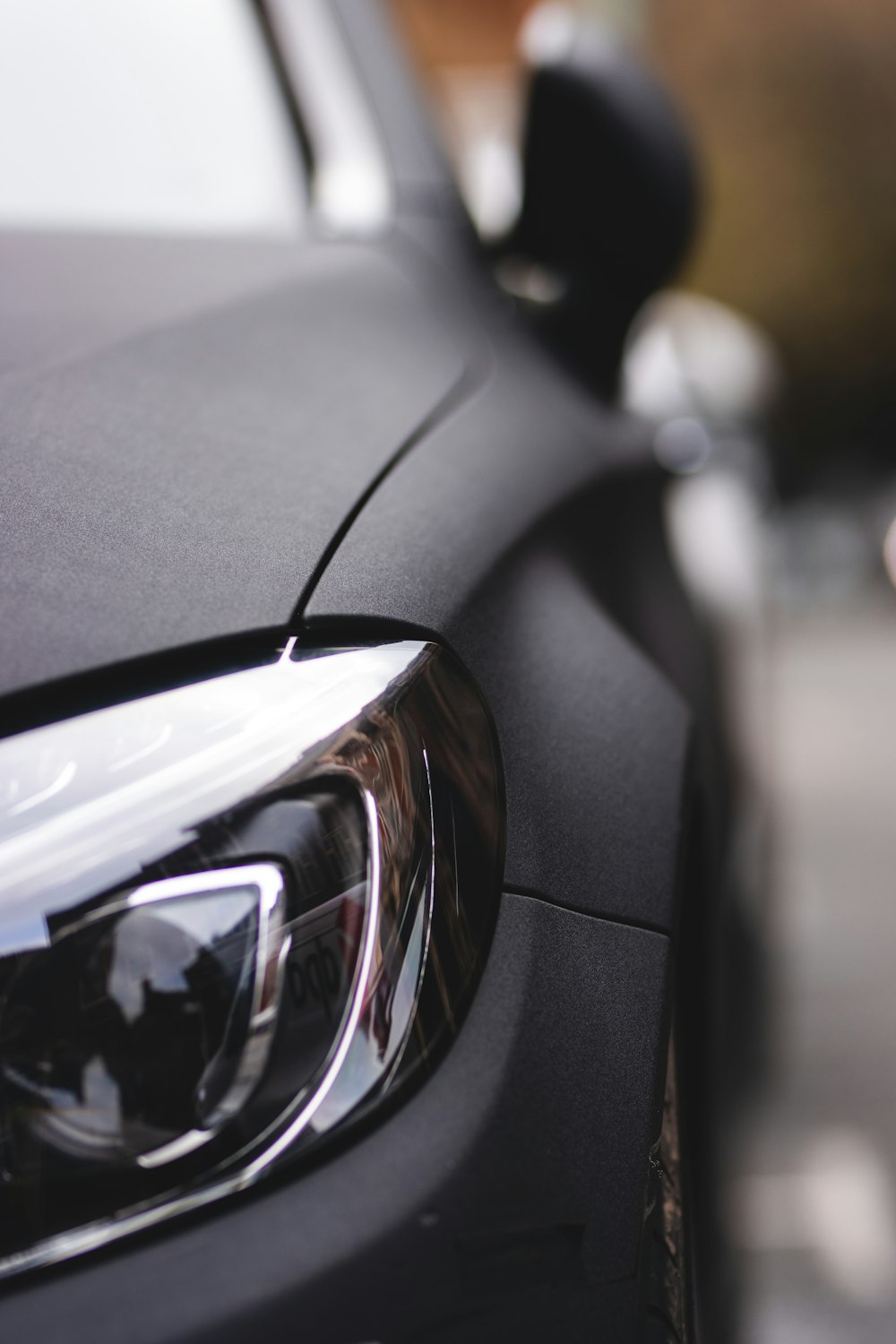 black car with black and silver headlight