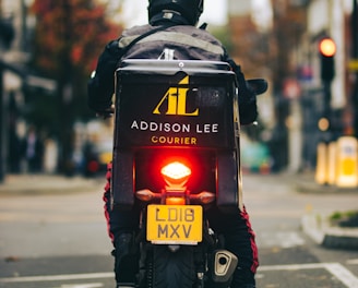 man in black helmet and black jacket with helmet on road during daytime