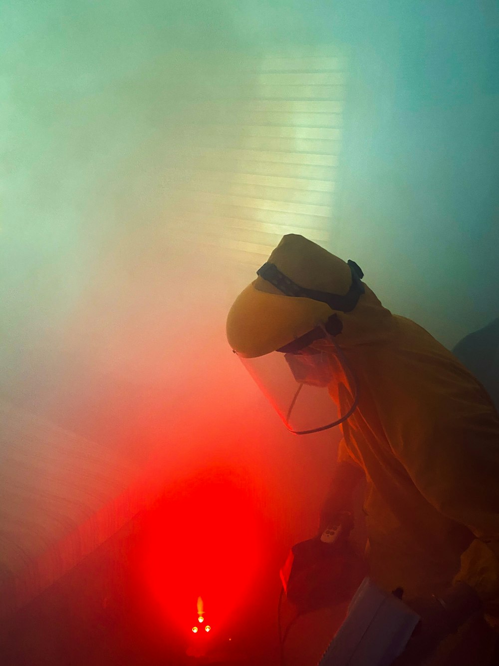 a man in a yellow suit is working on a red object