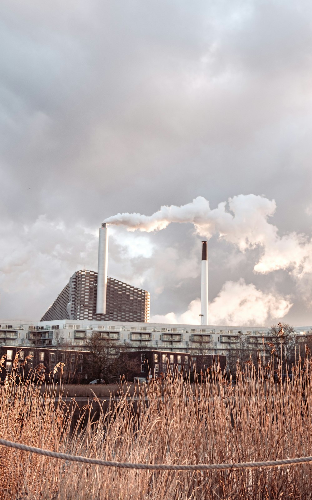 white and gray factory under cloudy sky during daytime