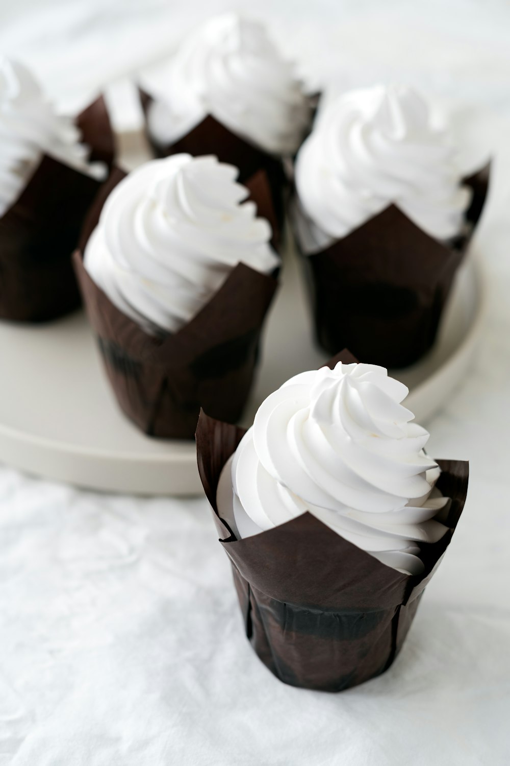 white and brown ice cream on brown cone