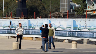 Photo of Mexinfra team discussing blueprints at a construction site in Puebla.