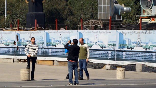 Photo of Jose Borbon discussing project plans with a client at a job site.