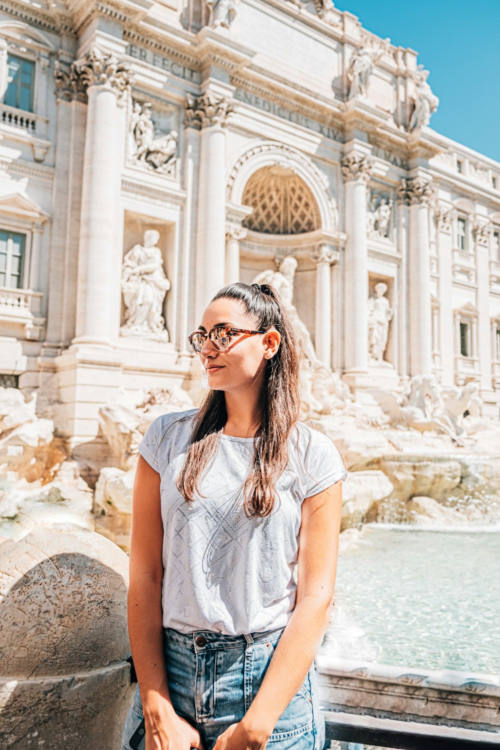 woman in white shirt wearing black sunglasses standing on water during daytime