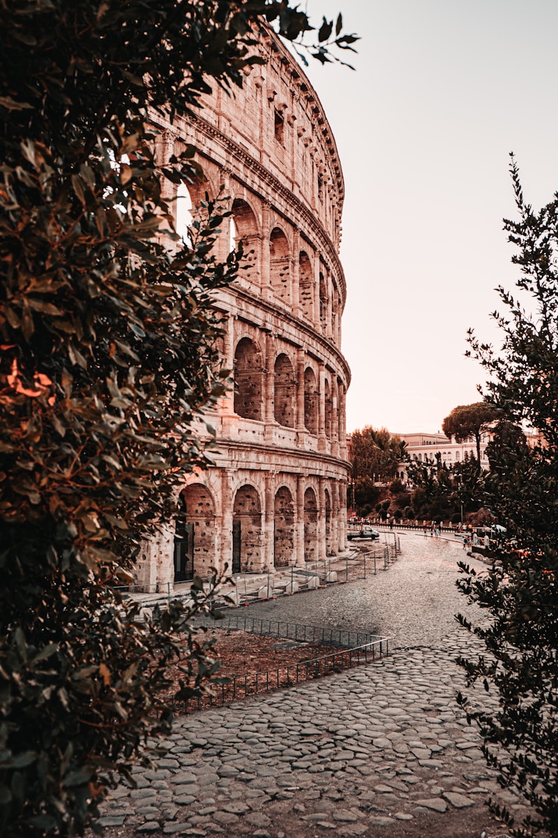The Colosseum in Rome illuminated at dusk — the heart of the neighbourhood covered in this dining guide