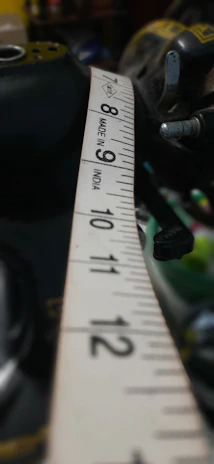 Close-up of a technician carefully measuring a pool liner with precision tools.