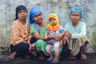 3 women sitting on ground